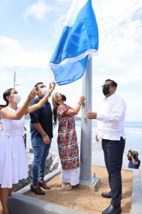 Evelyn Salgado iza bandera blue flag en playa de Zihuatanejo